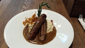 We loved how the meaty bangers sat astride the creamy mash, the onion straws observing ...